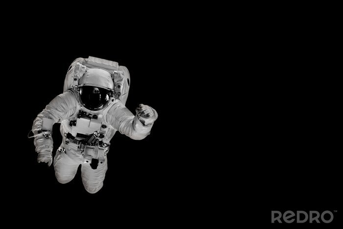 Papier peint  astronaut flies over the earth in space.