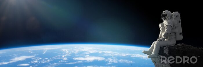 Papier peint  Astronaute assis avec la Terre en arrière-plan.