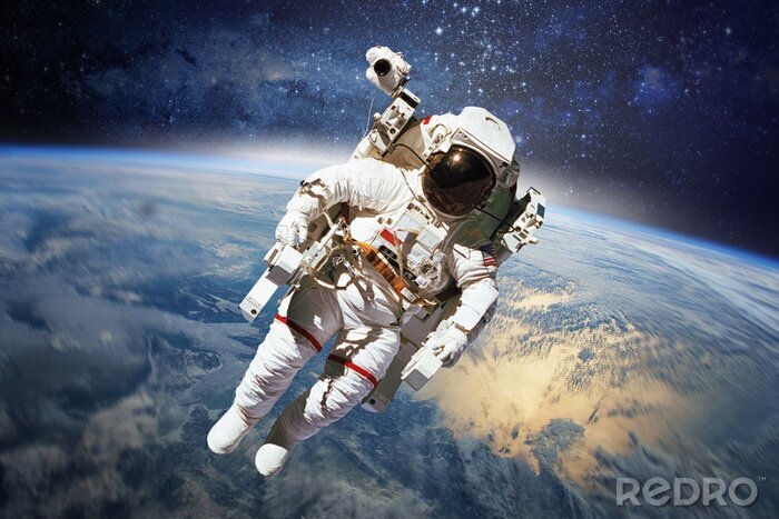 Papier peint  Astronaute dans l'espace avec la Terre en arrière-plan.