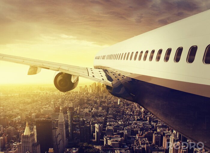 Papier peint  Avion au-dessus d'une grande ville