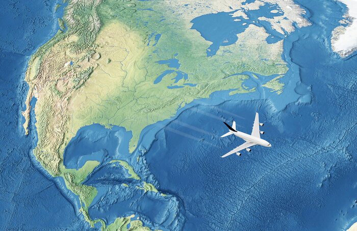 Papier peint  Avion civil blanc au-dessus de l'océan Atlantique à destination de l'Europe