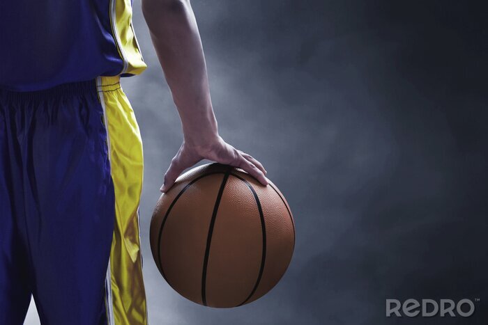 Papier peint  Basket ballon dans la main d'un joueur
