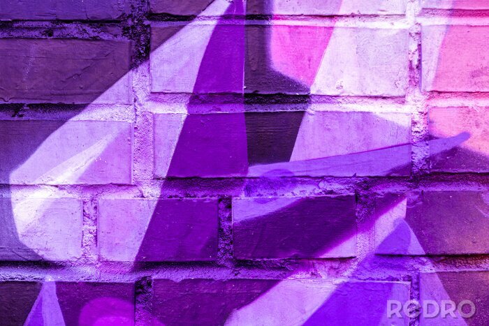 Papier peint  Beautiful bright colorful street art graffiti background. Abstract creative spray drawing fashion colors on the walls of the city. Urban Culture, black ,blue, purple , violet , neon texture