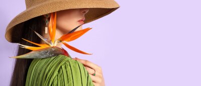 Papier peint  Beautiful young woman holding strelitzia flower on lilac background with space for text