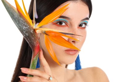 Papier peint  Beautiful young woman with strelitzia flower isolated on white
