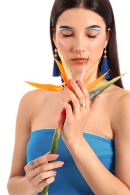 Papier peint  Beautiful young woman with strelitzia flower isolated on white