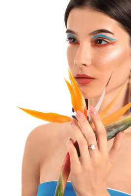 Papier peint  Beautiful young woman with strelitzia flower isolated on white
