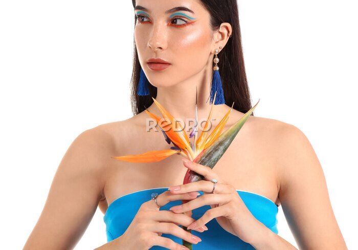 Papier peint  Beautiful young woman with strelitzia flower isolated on white