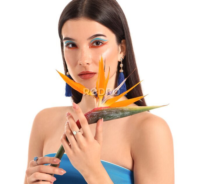 Papier peint  Beautiful young woman with strelitzia flower isolated on white