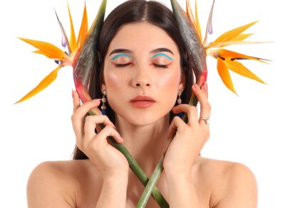 Papier peint  Beautiful young woman with strelitzia flowers isolated on white