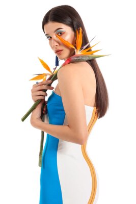 Papier peint  Beautiful young woman with strelitzia flowers isolated on white