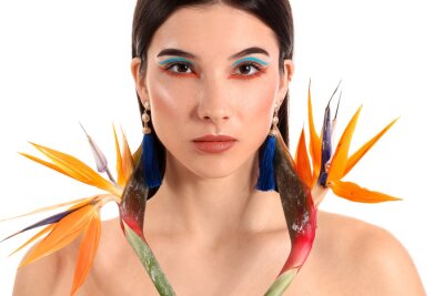 Papier peint  Beautiful young woman with strelitzia flowers isolated on white