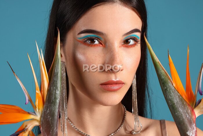 Papier peint  Beautiful young woman with strelitzia flowers on color background