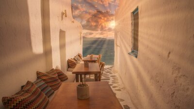 Papier peint  Benches with pillows in a typical Greek bar in Mykonos town with sea view, Cyclades islands, Greece. Travel concept.