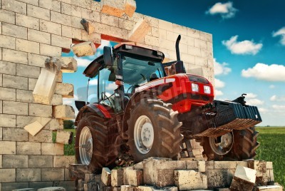 Papier peint  Brand new Tractor, powerfull agricultural working machine breaking through wall. Overcoming all obstacles in farming and agriculture production.