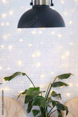 Papier peint  Christmas interior of a loft-style house with a black decorated retro lampshade and indoor plants of Strelitzia nicolai. New Year, comfort at home