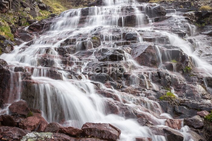 Papier peint  Close up details of scenic, colorful, powerful Monk's jump waterfall on Old mountain, the tallest in Serbia, streaming down the red, rocky cliff