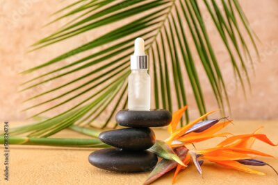 Papier peint  Composition with bottle of essential oil, strelitzia flower and spa stones on color background