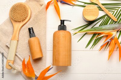 Papier peint  Composition with bottles of cosmetic products, bath supplies and strelitzia flowers on white background