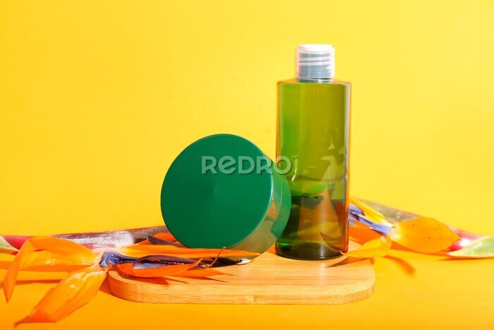 Papier peint  Composition with cosmetic products and strelitzia flowers on color background
