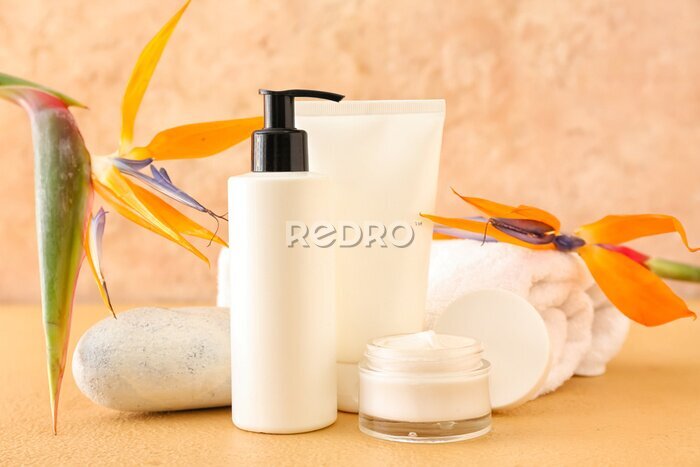 Papier peint  Composition with cosmetic products and strelitzia flowers on color background