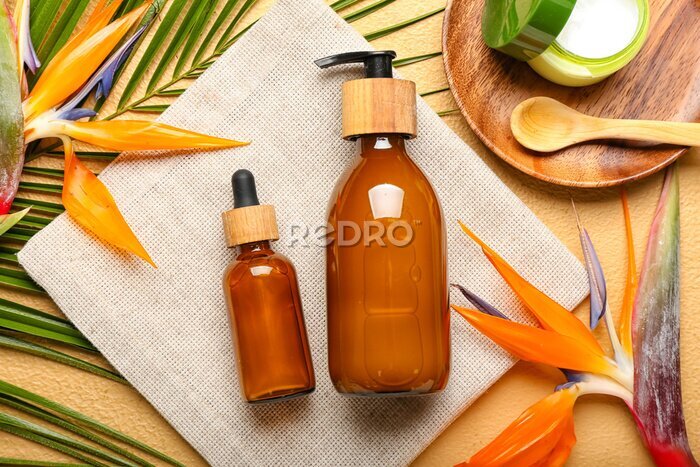 Papier peint  Composition with cosmetic products, strelitzia flowers and palm leaf on color background