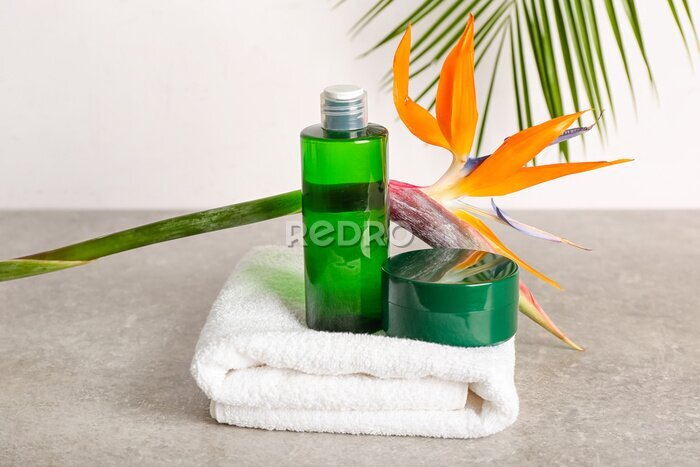 Papier peint  Composition with cosmetic products, towel and strelitzia flower on light background