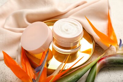 Papier peint  Composition with jar of cream and strelitzia flowers on light background