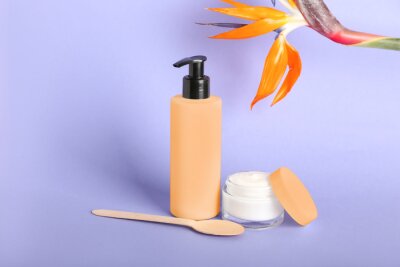 Papier peint  Cosmetic products and strelitzia flower on lilac background