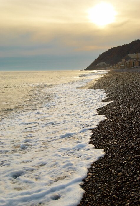 Papier peint  Coucher de soleil au-dessus de la plage.