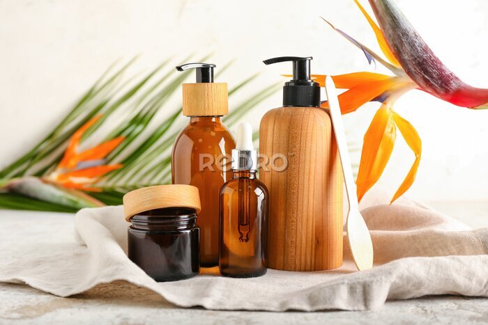 Papier peint  Different cosmetic products and strelitzia flower on light background