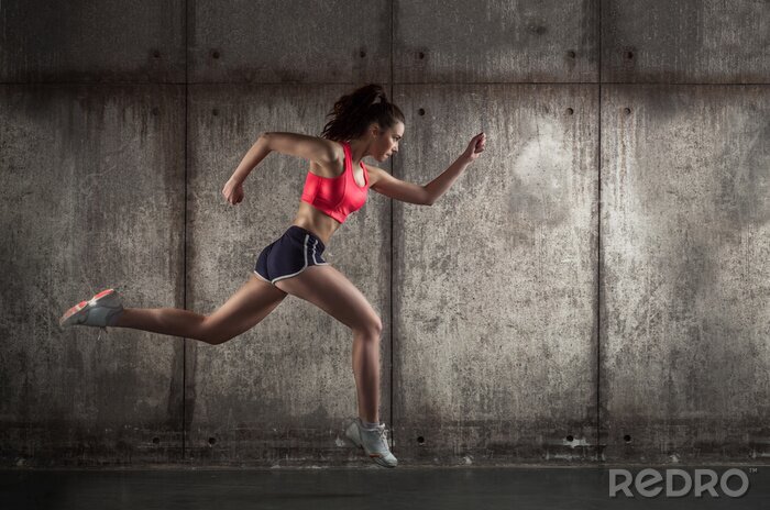 Papier peint  Femme courant en tenue de sport de profil