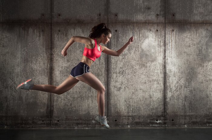 Papier peint  Femme courant en tenue de sport de profil