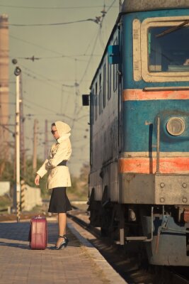 Papier peint  Femme de lunettes de soleil de train en attente sur la station de chemin de fer.