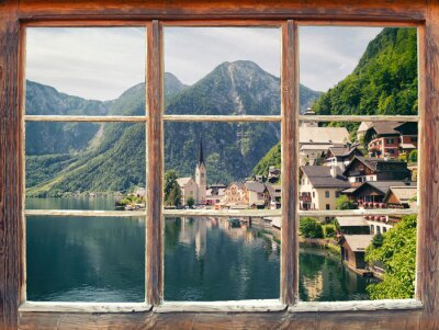 Fenêtre avec une vue sur des montagnes et des chalets