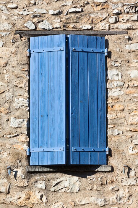 Papier peint  Fenêtre bleue sur un mur de pierre