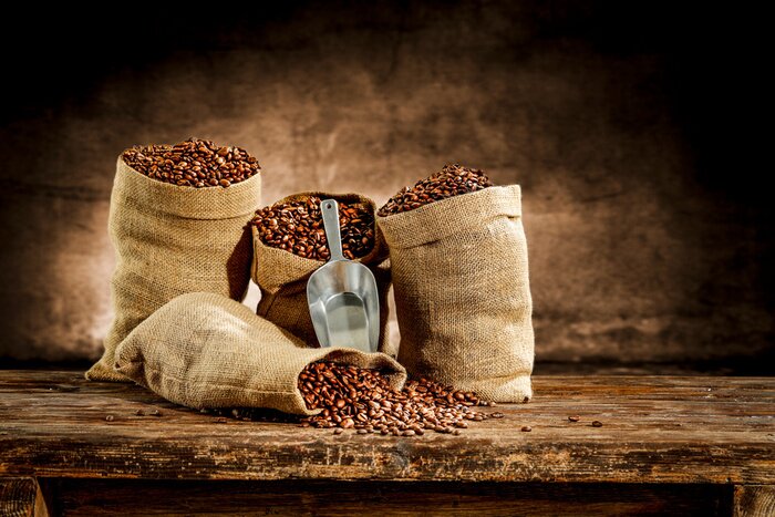 Papier peint  Fresh old sack of coffee grains and brown old wall background 