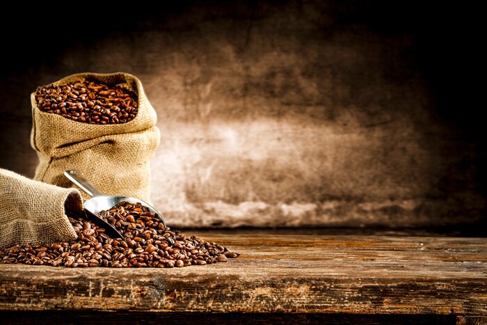 Papier peint  Fresh old sack of coffee grains and brown old wall background 
