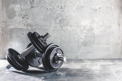 Papier peint  Haltères et poids sur un fond en béton