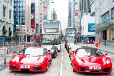 Papier peint  Hong Kong, Hong Kong S.A.R. - May 19, 2013: Modern Ferarri cars on Nathan Rd in Hong Kong. Nathan Road is a main thoroughfare through Kowloon and is line with shops and restaurants.