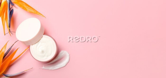 Papier peint  Jar of cream and beautiful strelitzia flowers on pink background with space for text