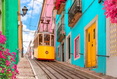 Papier peint  Lisbon, Portugal - Yellow tram on a street with colorful houses and flowers on the balconies - Bica Elevator going down the hill of Chiado.