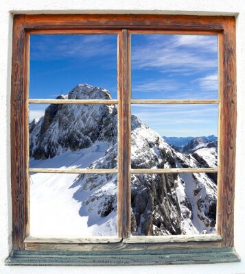 Montagnes enneigées derrière une fenêtre