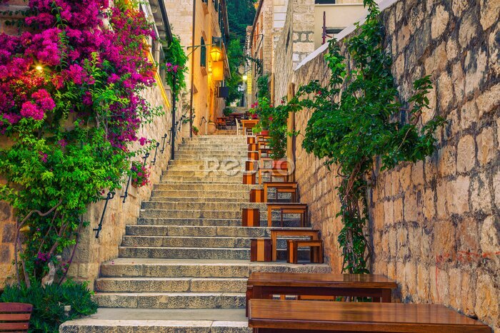 Papier peint  Narrow street and street cafe decorated with flowers, Hvar, Croatia