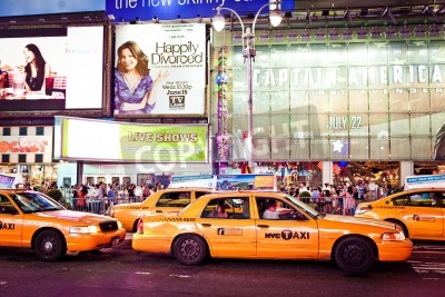 Papier peint  NEW YORK CITY - JULY 1: Taxi cabs riding throughTimes Square featured with Broadway Theaters and animated LED signs. Times Square is a symbol of New York City. July 1, 2011 in Manhattan, New York City