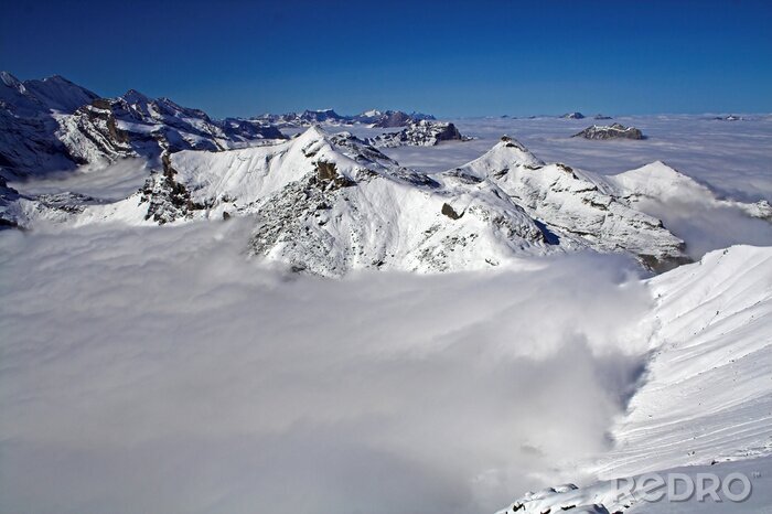 Papier peint  Pics alpins dans les nuages