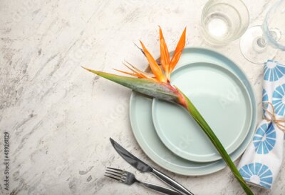 Papier peint  Simple table setting with bird of paradise flower on light grunge background