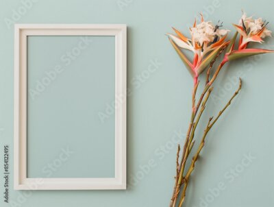 Papier peint  teal background with empty white frame and strelitzia flower, delicate and refined vintage style
