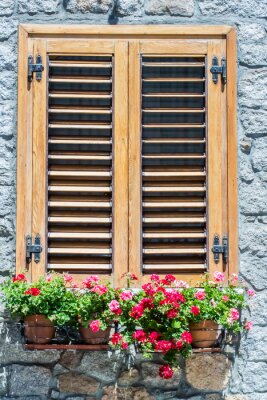 Papier peint  Typical window of a  stone house with wooden shutters closed and