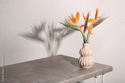 Papier peint  Vase with beautiful strelitzia flowers on table